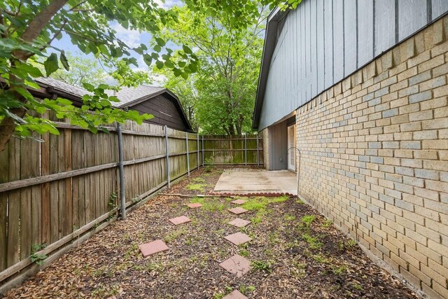 1017 Westminster Ln, Garland, TX 75040 - fenced backyard featuring a patio