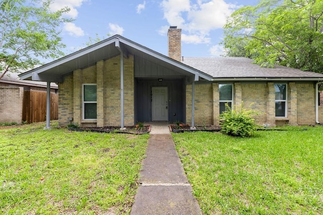1017 Westminster Ln, Garland, TX 75040 - view of front of home featuring a chimney, brick siding, and a shingled roof