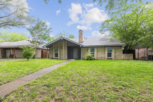 1017 Westminster Ln, Garland, TX 75040 - view of front of home with a chimney, cooling unit, and brick siding
