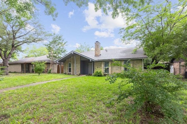 1017 Westminster Ln, Garland, TX 75040 - back of property with a lawn and a chimney