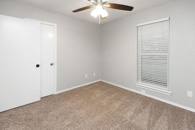 1017 Westminster Ln, Garland, TX 75040 - unfurnished bedroom with carpet floors, baseboards, and a ceiling fan