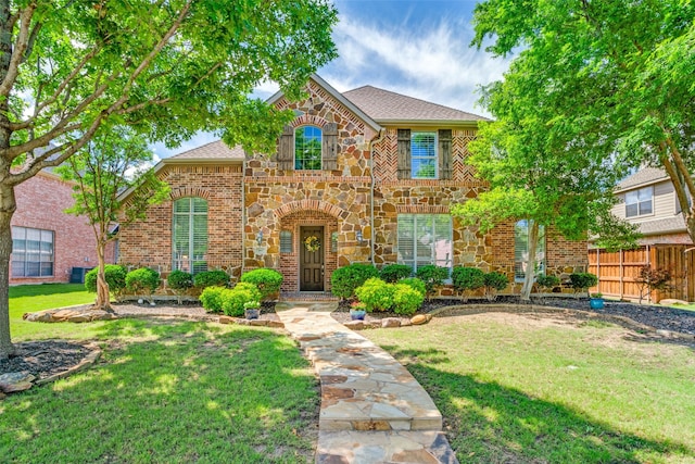 1615 San Andres Dr, Frisco, TX 75033 - view of front of home featuring stone siding, brick siding, and roof with shingles