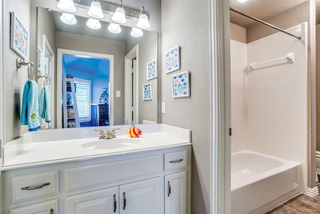 1615 San Andres Dr, Frisco, TX 75033 - bathroom featuring a textured wall, vanity, and shower / tub combination