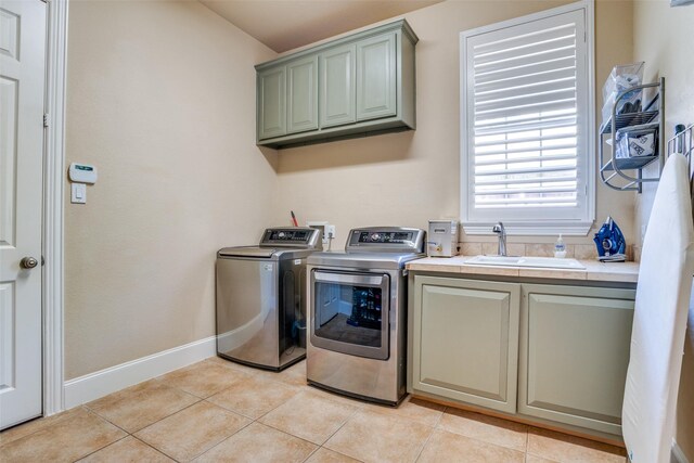 1615 San Andres Dr, Frisco, TX 75033 - washroom with cabinet space, separate washer and dryer, light tile patterned floors, and baseboards