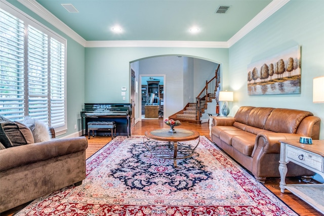 1615 San Andres Dr, Frisco, TX 75033 - living area featuring arched walkways, wood finished floors, ornamental molding, stairway, and recessed lighting