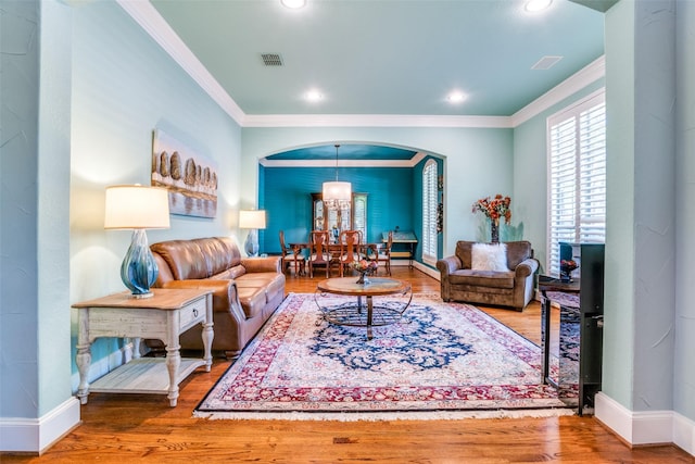 1615 San Andres Dr, Frisco, TX 75033 - living area featuring arched walkways, crown molding, wood finished floors, baseboards, and recessed lighting