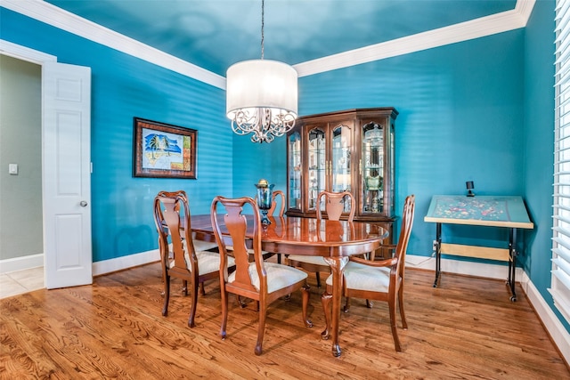 1615 San Andres Dr, Frisco, TX 75033 - dining area with ornamental molding, a chandelier, baseboards, and wood finished floors