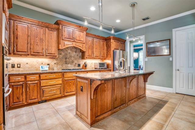 1615 San Andres Dr, Frisco, TX 75033 - kitchen with appliances with stainless steel finishes, brown cabinets, a kitchen breakfast bar, and crown molding