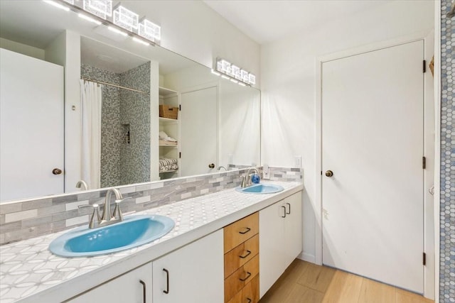 3020 N 43rd St, Waco, TX 76710 - bathroom with tasteful backsplash, double vanity, wood finished floors, and a shower with shower curtain