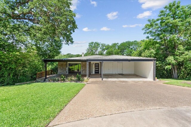 3020 N 43rd St, Waco, TX 76710 - view of front facade featuring concrete driveway, a front yard, and metal roof