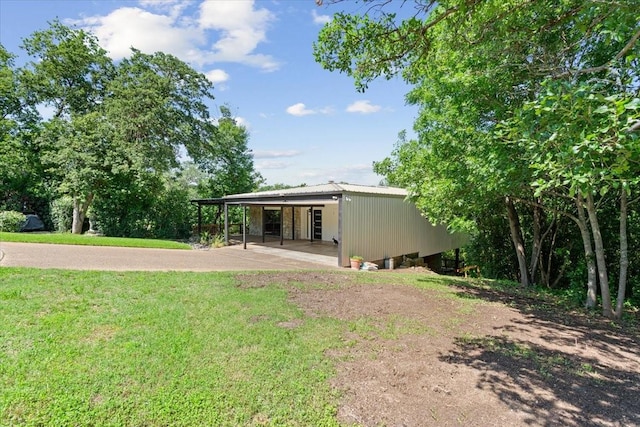 3020 N 43rd St, Waco, TX 76710 - back of property with a lawn, driveway, and a carport