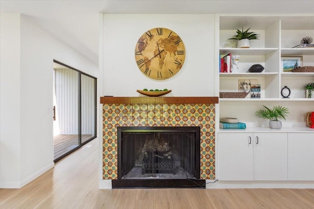 3020 N 43rd St, Waco, TX 76710 - detailed view of a tiled fireplace, wood finished floors, and baseboards