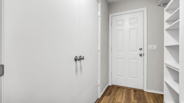entryway with wood finished floors and baseboards