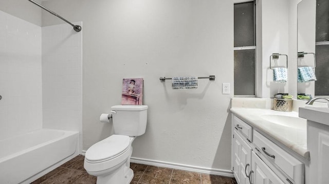 bathroom with baseboards, toilet, vanity, tile patterned floors, and shower / washtub combination
