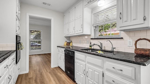 kitchen featuring black appliances, a sink, and white cabinets
