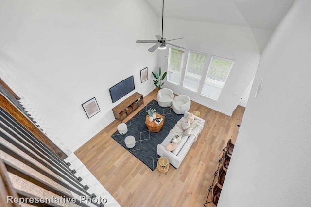 2418 Plumeria, Celina, TX 75009 - living room featuring wood finished floors, ceiling fan, baseboards, and high vaulted ceiling