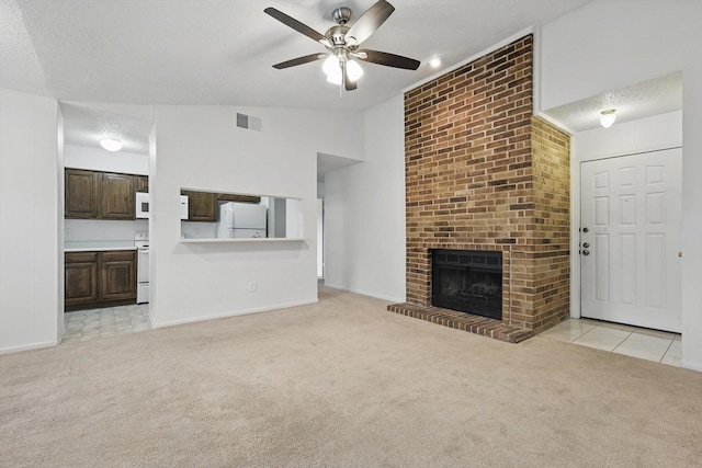 2000 Willoughby Ln Unit 5520, Arlington, TX 76011 - unfurnished living room with light carpet, ceiling fan, a textured ceiling, a fireplace, and vaulted ceiling