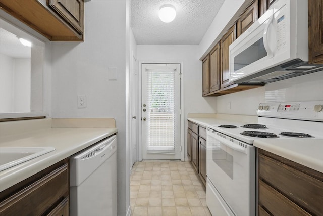 2000 Willoughby Ln Unit 5520, Arlington, TX 76011 - kitchen with white appliances, light countertops, a textured ceiling, and a sink