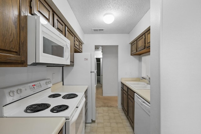 2000 Willoughby Ln Unit 5520, Arlington, TX 76011 - kitchen with white appliances, light countertops, a textured ceiling, a sink, and dark brown cabinetry