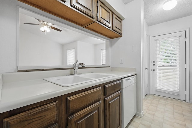 2000 Willoughby Ln Unit 5520, Arlington, TX 76011 - kitchen with white dishwasher, a sink, light countertops, ceiling fan, and a textured ceiling