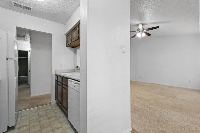 2000 Willoughby Ln Unit 5520, Arlington, TX 76011 - kitchen with a textured ceiling, light colored carpet, a ceiling fan, white appliances, and light countertops