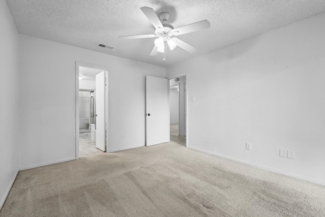 2000 Willoughby Ln Unit 5520, Arlington, TX 76011 - unfurnished bedroom with carpet, a textured ceiling, connected bathroom, a ceiling fan, and baseboards