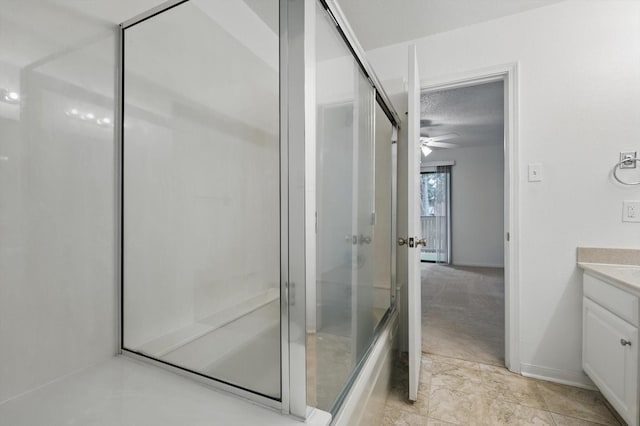 2000 Willoughby Ln Unit 5520, Arlington, TX 76011 - bathroom featuring a shower stall, vanity, a ceiling fan, a textured ceiling, and baseboards