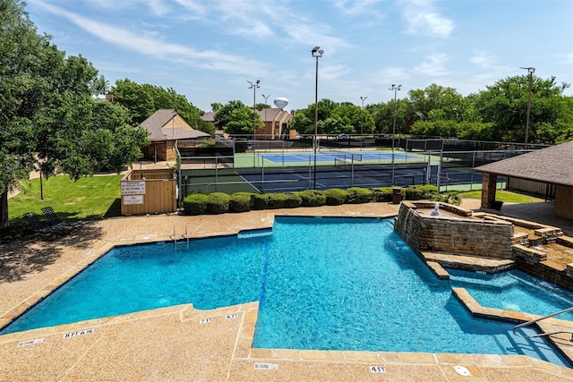 2000 Willoughby Ln Unit 5520, Arlington, TX 76011 - community pool featuring fence, a tennis court, and view of scattered trees