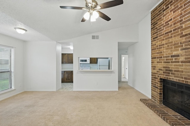 2000 Willoughby Ln Unit 5520, Arlington, TX 76011 - unfurnished living room with light carpet, lofted ceiling, a ceiling fan, baseboards, and a textured ceiling