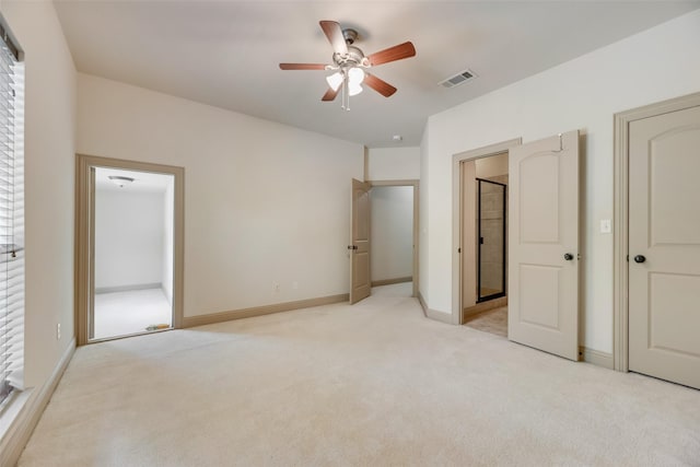 unfurnished bedroom with light colored carpet, baseboards, ceiling fan, and lofted ceiling