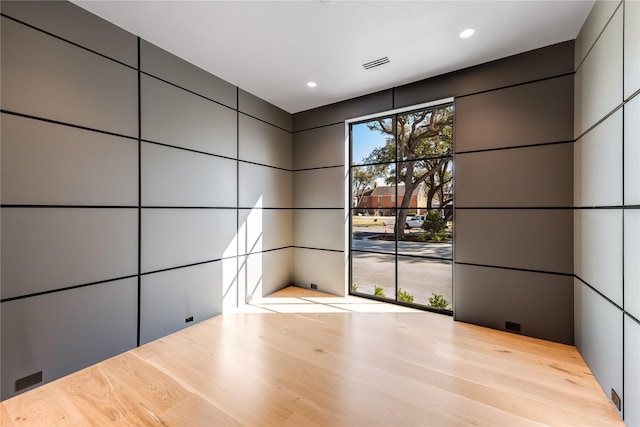 empty room featuring recessed lighting and wood finished floors