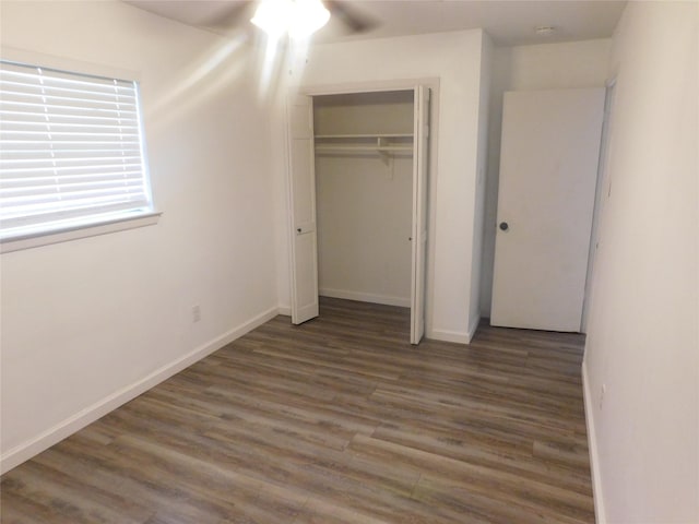 4902 Meyers Ln, Bellmead, TX 76705 - unfurnished bedroom with wood finished floors, a closet, baseboards, and ceiling fan