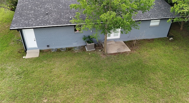 4902 Meyers Ln, Bellmead, TX 76705 - back of property featuring roof with shingles, brick siding, and a lawn