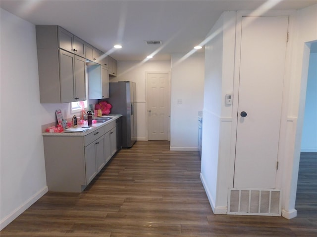 4902 Meyers Ln, Bellmead, TX 76705 - kitchen with dark wood-type flooring, light countertops, baseboards, and recessed lighting