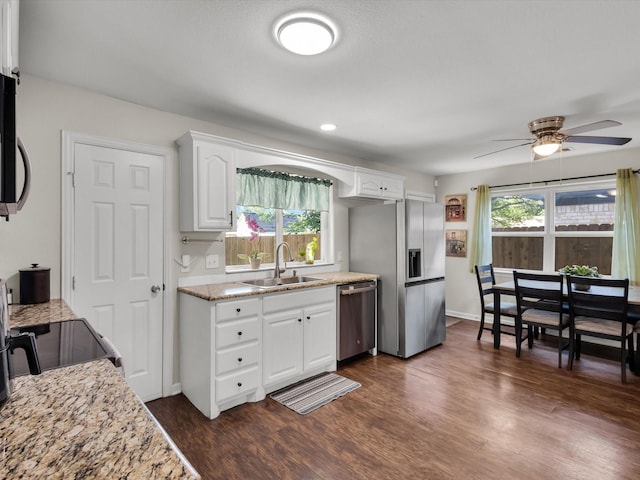 kitchen with stainless steel appliances, a sink, dark wood-style flooring, a ceiling fan, and white cabinets