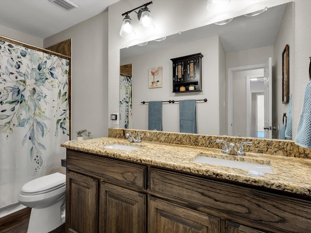 full bathroom featuring toilet, double vanity, wood finished floors, and a shower with shower curtain