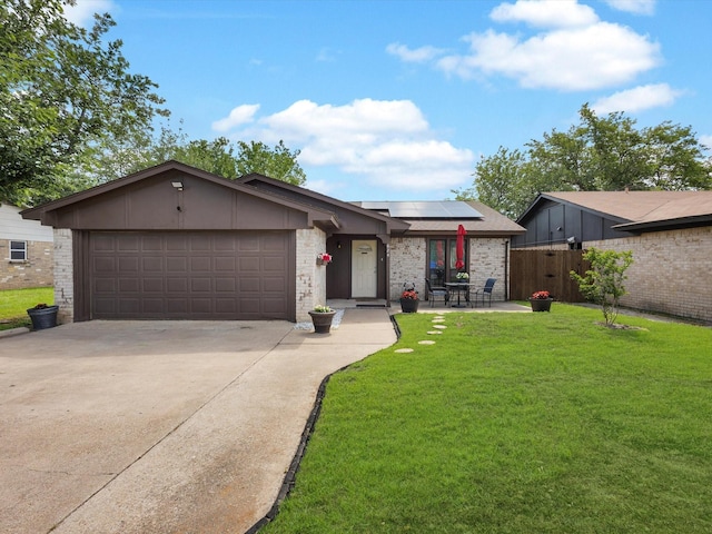 624 Hallvale Dr, White Settlement, TX 76108 - view of front of house with solar panels, an attached garage, driveway, and brick siding