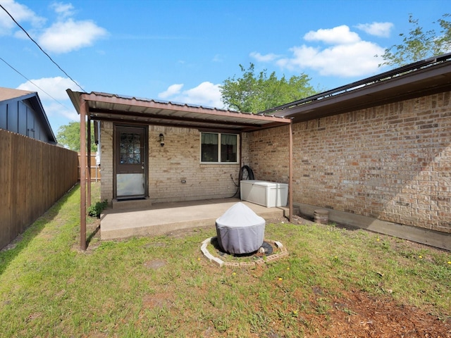 rear view of house with a patio and brick siding