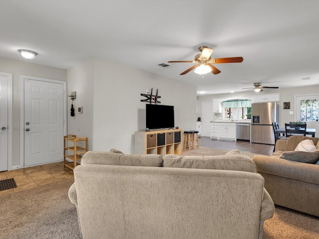 living room with ceiling fan and light tile patterned floors