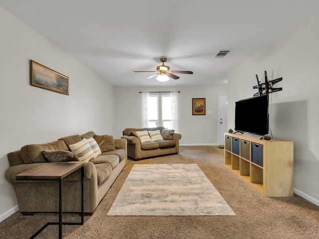carpeted living room with ceiling fan and baseboards