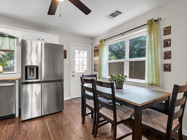 dining room with a ceiling fan, dark wood-style flooring, and baseboards