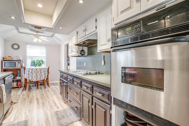 814 Branding Iron Trl, Granbury, TX 76049 - kitchen featuring appliances with stainless steel finishes, a raised ceiling, white cabinetry, light wood-type flooring, and baseboards