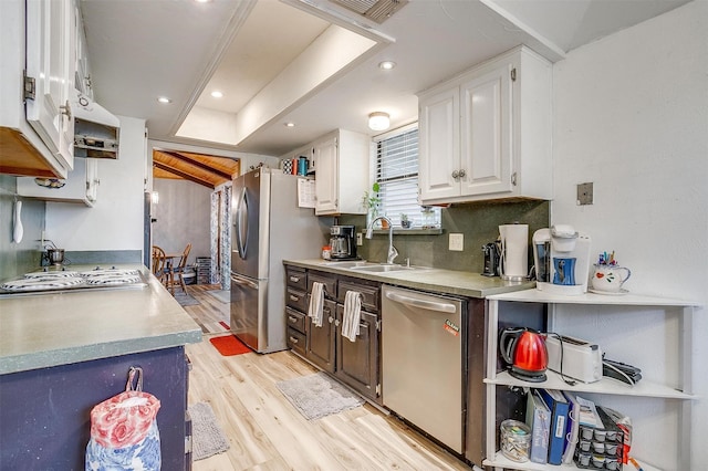 814 Branding Iron Trl, Granbury, TX 76049 - kitchen with appliances with stainless steel finishes, a sink, light wood-style floors, white cabinets, and light countertops
