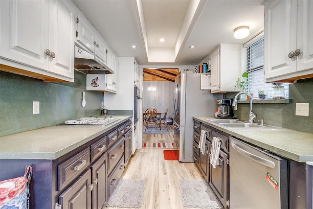814 Branding Iron Trl, Granbury, TX 76049 - kitchen featuring appliances with stainless steel finishes, a sink, light wood finished floors, white cabinets, and recessed lighting