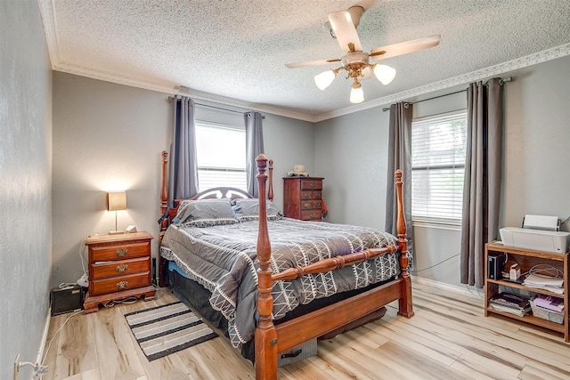 814 Branding Iron Trl, Granbury, TX 76049 - bedroom with ornamental molding, multiple windows, a textured ceiling, wood finished floors, and a ceiling fan