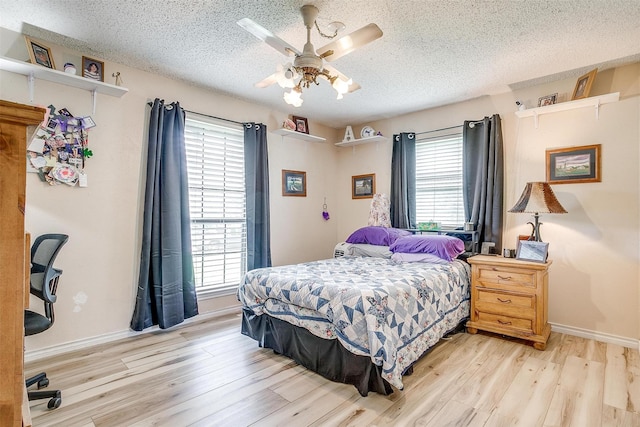 814 Branding Iron Trl, Granbury, TX 76049 - bedroom featuring multiple windows, light wood-style floors, a textured ceiling, baseboards, and ceiling fan
