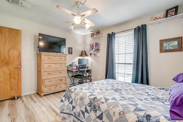 814 Branding Iron Trl, Granbury, TX 76049 - bedroom with a textured ceiling, light wood-type flooring, and a ceiling fan