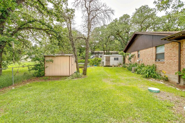 814 Branding Iron Trl, Granbury, TX 76049 - view of yard with a storage shed and an outbuilding