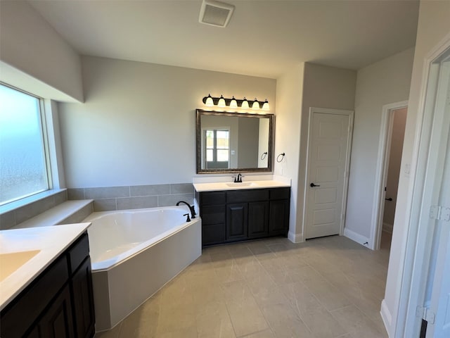 full bath featuring a garden tub and two vanities