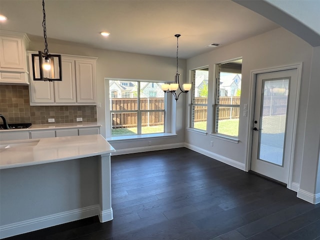 kitchen with light countertops, baseboards, white cabinets, dark wood finished floors, and recessed lighting